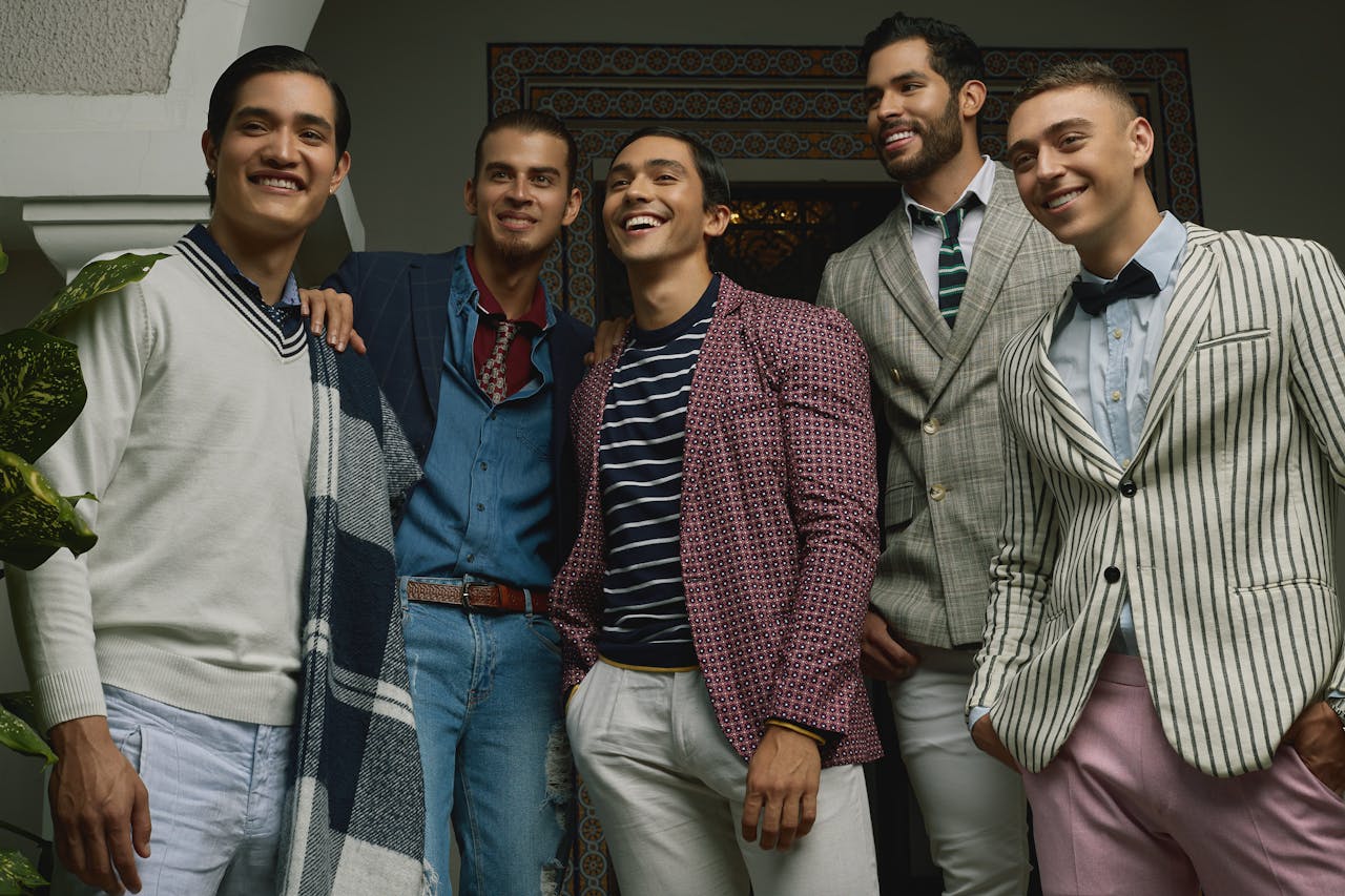 Mastering the First Impression: Your intriguing post title goes here Five men in fashionable attire posing indoors, exuding confidence and style.
